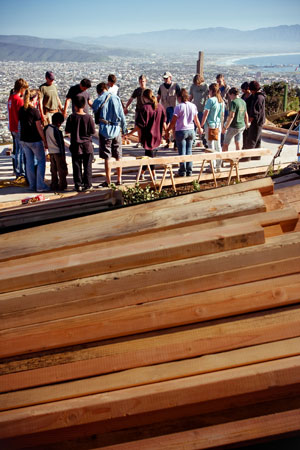 The construction team prays. © Jessica Fairchild