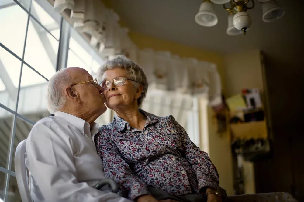 Elderly couple kissing