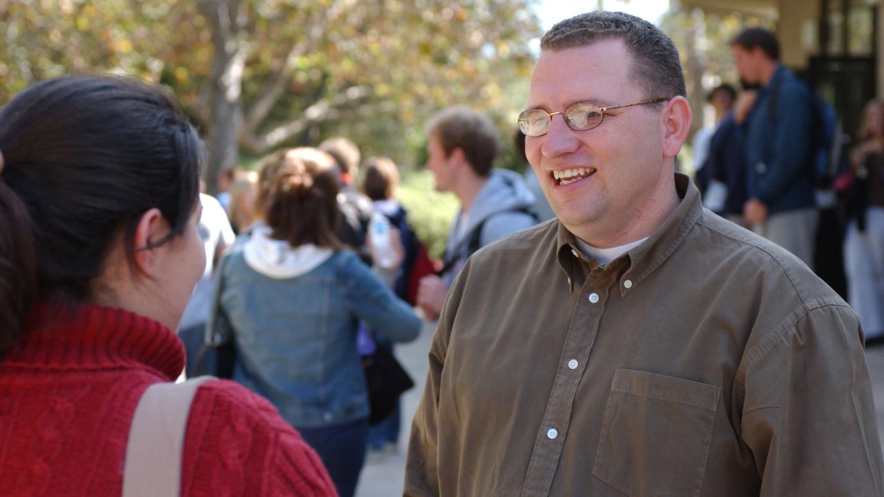 Stu Cleek talks to a student outside of Murchison Gym