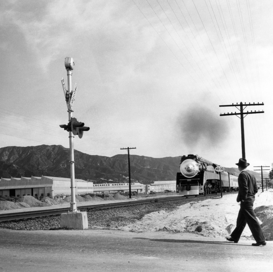 Ansel Adams image of man walking towards oncoming train in Burbank, CA.